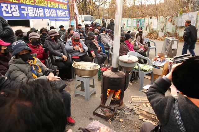 Residents demand residency certificates and land purchase rights for redevelopment from the Seoul Metropolitan Government at the entrance of Guryong Village Seoul Nov 25 2024 AJP Han Jun-gu