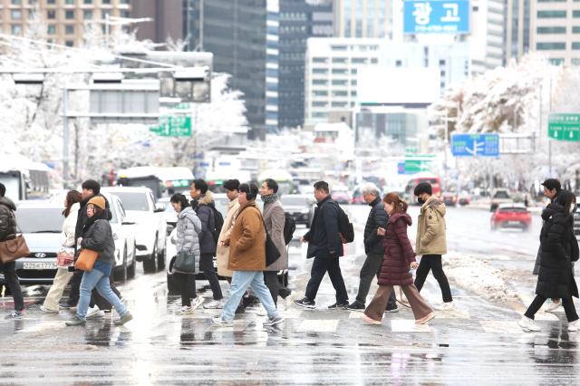 Snow removal workers clear a street in Seoul on Nov 27 2024 AJP Han Jun-gu