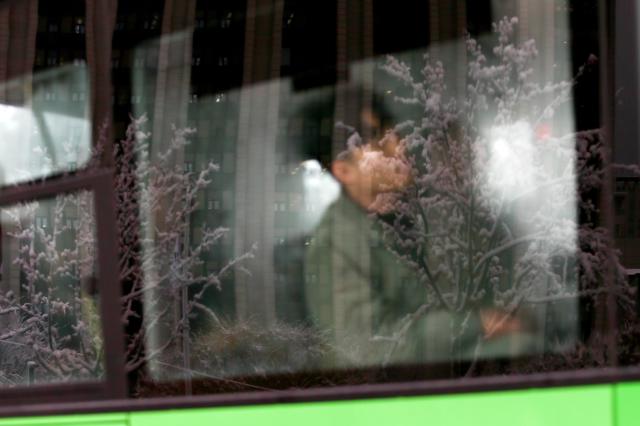 A passenger sits on a bus during snowfall in Seoul on Nov 27 2024 AJP Kim Dong-woo