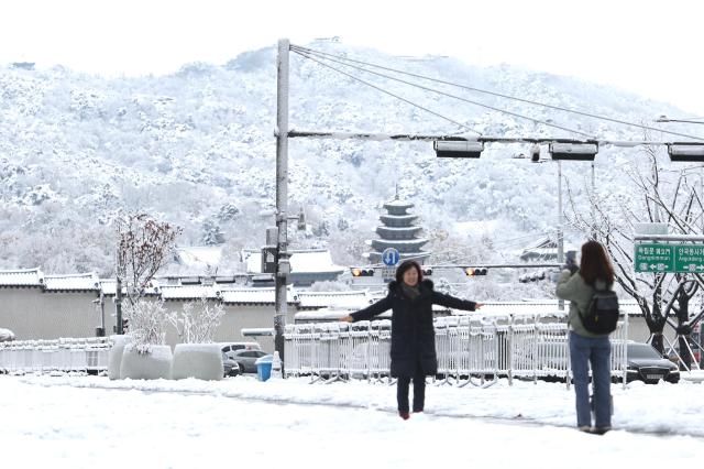 Citizens take photos of snow-covered trees in Seoul on Nov 27 2024 AJP Han Jun-gu