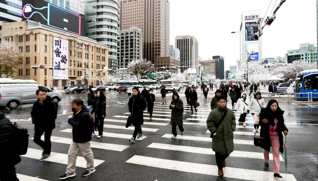 Snow removal workers clear a street in Seoul on Nov 27 2024 AJP Kim Dong-woo