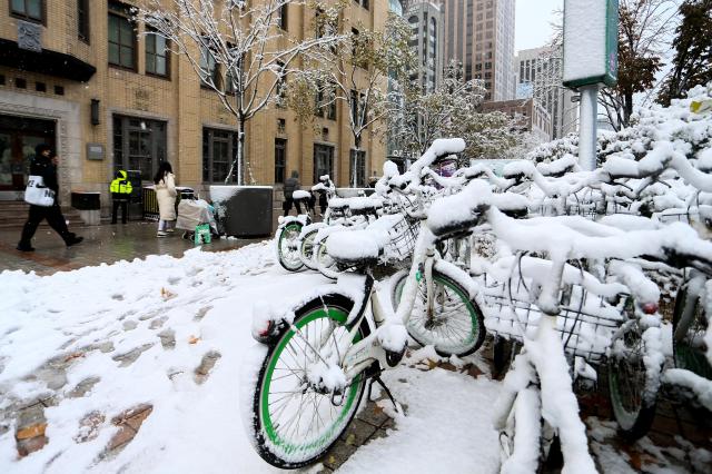 People walk through snow-covered streets in Seoul on Nov 27 2024 AJP Kim Dong-woo