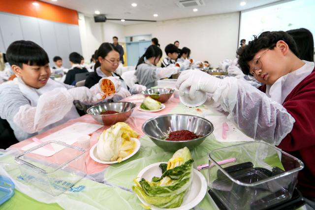 Students prepare ingredients during a traditional kimjang program at the National Folk Museum of Korea in Seoul on Nov 28 2024 AJP Kim Dong-woo