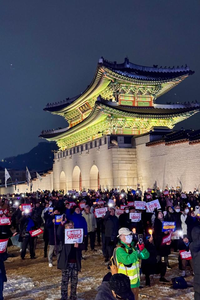 Protesters hold candles during a rally against presidential vetoes near Gwanghwamun Square in Seoul on Nov 30 2024 AJP Kim Dong-woo