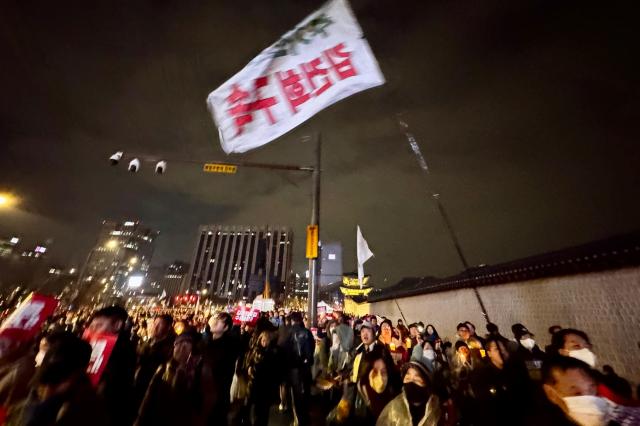 Protesters brave rain during a demonstration against presidential vetoes in Seoul on Nov 30 2024 AJP Kim Dong-woo