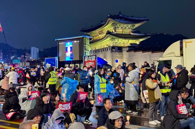 Protesters hold candles during a rally against presidential vetoes near Gwanghwamun Square in Seoul on Nov 30 2024 AJP Kim Dong-woo