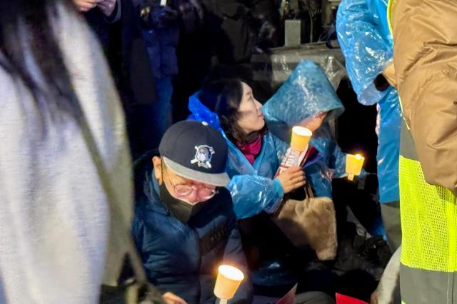 Protesters hold candles during a rally against presidential vetoes near Gwanghwamun Square in Seoul on Nov 30 2024 AJP Kim Dong-woo