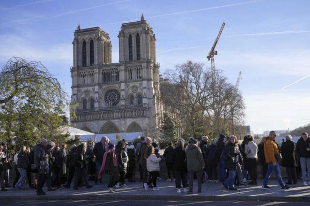 People gather as French President Emmanuel Macron visits the renovated Notre Dame Cathedral in Paris on Nov 29 2024 AP-Yonhap