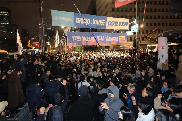 Protesters gather outside National Assembly in Seoul past midnight Dec 4 following President Yoons martial law declaration Yonhap