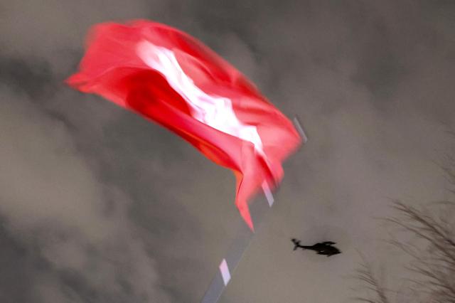 A military helicopter flies over the National Assembly building in Yeouido after President Yoon Suk Yeol declared martial law on Dec 3 AJP Kim Dong-woo