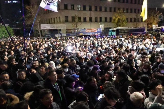 Citizens gathered in front of the National Assembly building in Yeouido cheer moments after the resolution to lift martial law was passed at about 100 am on Dec 4 AJP Han Jun-gu