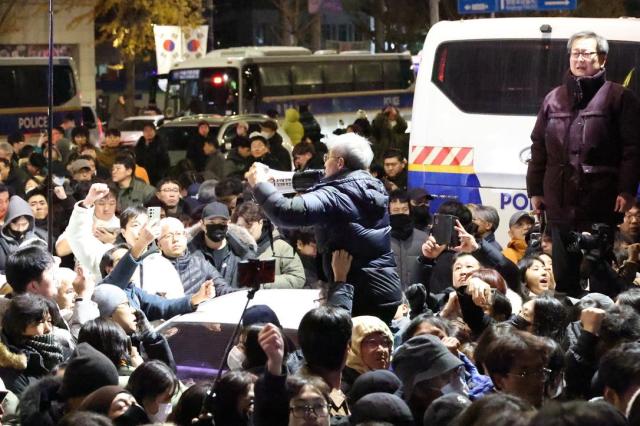 Citizens gathered in front of the National Assembly building in Yeouido cheer moments after the resolution to lift martial law was passed at about 100 am on Dec 4 AJP Han Jun-gu