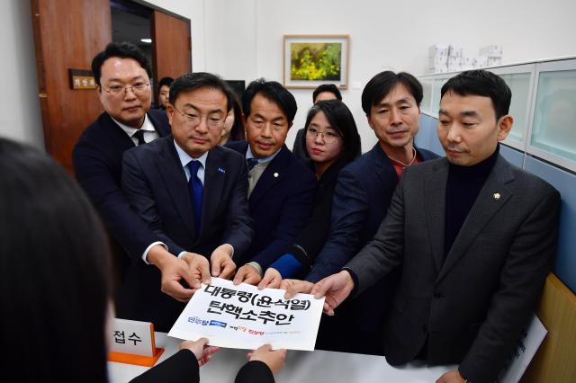 4일 서울 여의도 국회에서 개혁신당 천하람 원내대표 조국혁신당 신장식 의원 진보당 윤종오 원내대표 기본소득당 용혜인 대표 사회민주당 한창민 대표 더불어민주당 김용민 의원이 야6당이 공동발의한 윤석열 대통령 탄핵소추안을 제출하고 있다 사진연합뉴스