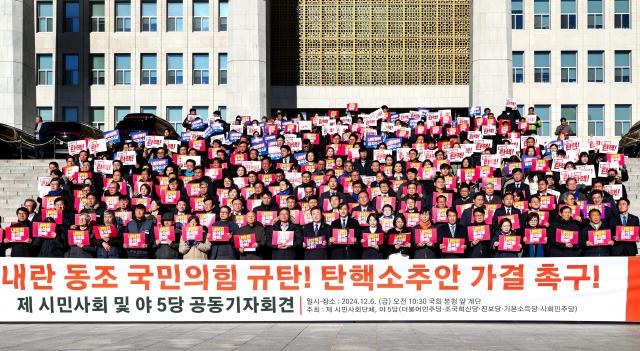 Participants hold signs and chant slogans during a press conference by opposition parties and civic groups at the National Assembly in Seoul on Dec 6 2024 AJP Kim Dong-woo