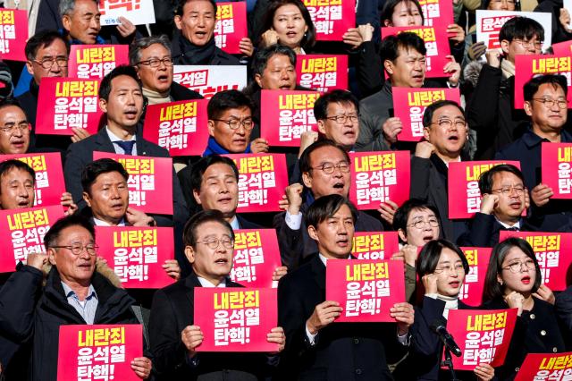 Participants hold signs and chant slogans during a press conference by opposition parties and civic groups at the National Assembly in Seoul on Dec 6 2024 AJP Kim Dong-woo