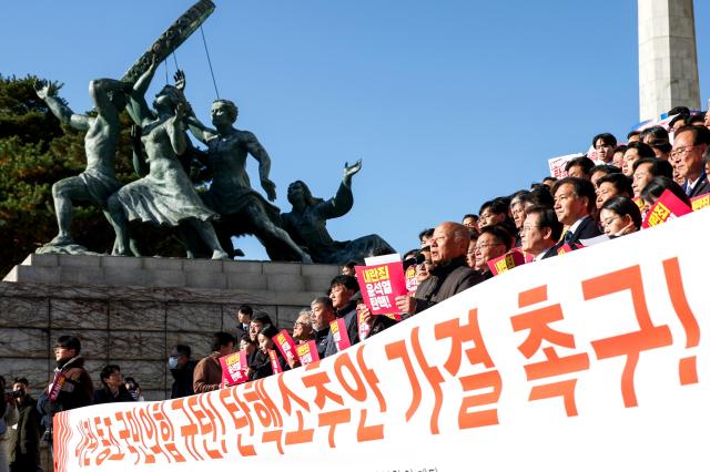 Participants hold signs and chant slogans during a press conference by opposition parties and civic groups at the National Assembly in Seoul on Dec 6 2024 AJP Kim Dong-woo