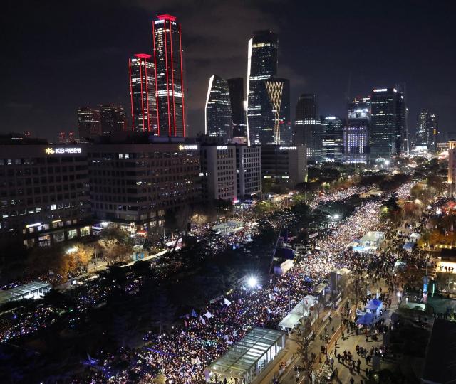 Citizens participate in a protest in front of the National Assembly building in Yeouido on Dec 7 As of 430 pm police estimated the crowd at 45000 AJP Han Jun-gu