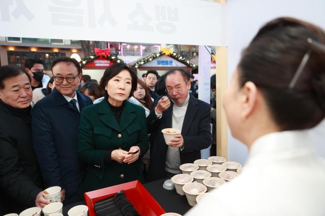 오영주 중소벤처기업부 장관이 지난 6일 서울 마포구 홍대 레드로드에서 열린 12월 동행축제 개막식 행사장을 둘러보며 참석 상인들을 격려하고 있다 사진중소벤처기업부