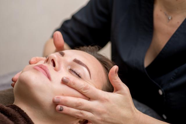 A massage therapist performing massage on client Getty Images Bank