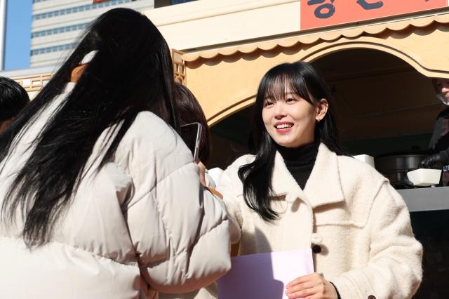 Kang Han-na distributes dumplings to visitors during the About Family movie release dumpling truck event in Seoul on Dec 10 2024 AJP Han Jun-gu