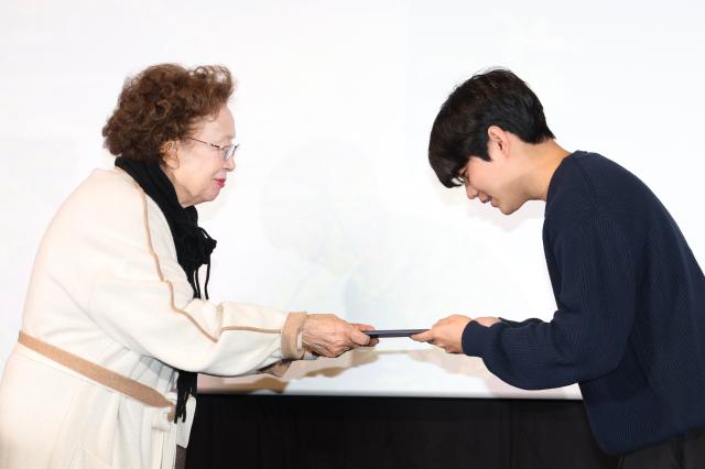 Na Moon-hee presents an award to the recipient during the I Moon Hee awards ceremony at CGV in Yongsan Seoul on Dec 11 2024 AJP Han Jun-gu