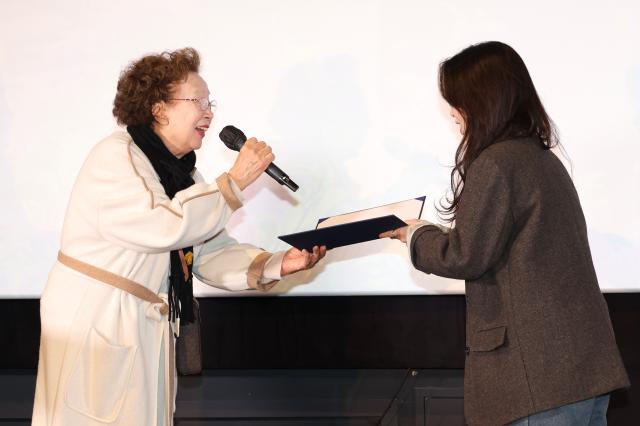 Na Moon-hee presents an award to the recipient during the I Moon Hee awards ceremony at CGV in Yongsan Seoul on Dec 11 2024 AJP Han Jun-gu