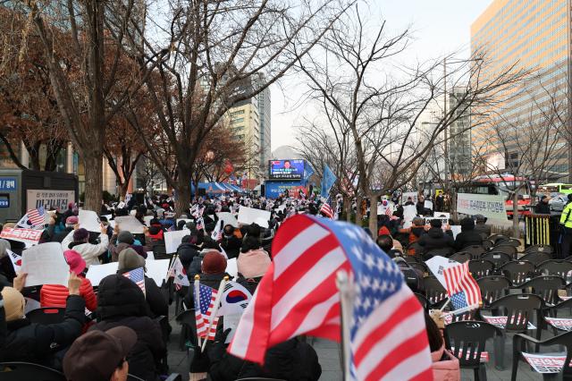 People gather to protest against the impeachment of President Yoon Suk Yeol and calling for the arrest of Lee Jae-myung leader of the main opposition Democratic Party DP near Gwanghwamun Station on Dec 11 2024 AJP Han Jun-gu