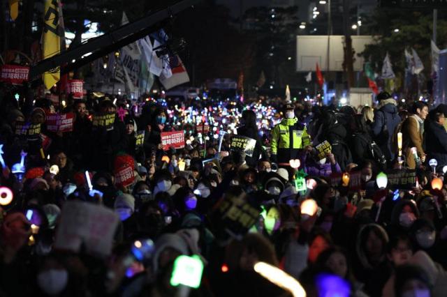 People gather in front of the National Assembly in Yeouido Seoul calling for President Yoon Suk Yeols impeachment on Dec 11 2024 Yonhap