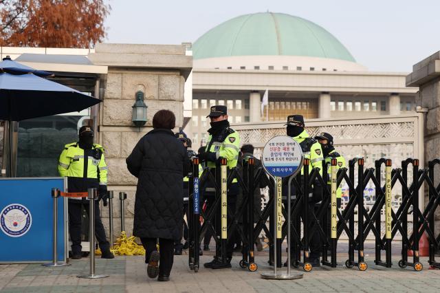 Police inspect passes in front of the National Assembly on Dec 13 2024 Yonhap 