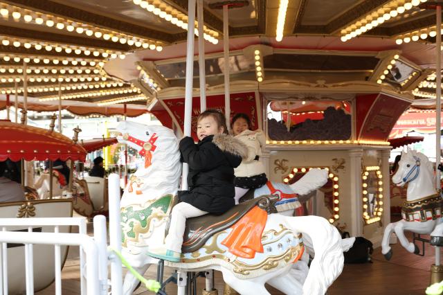 Children ride a carousel at the Christmas market in Jamsil Seoul Dec 13 2024 AJP Han Jun-gu