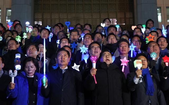 더불어민주당 박찬대 원내대표를 비롯한 의원들이 윤석열 대통령에 대한 2차 탄핵소추안 표결을 하루 앞둔 13일 오후 국회 본관 앞에서 응원봉을 들고 탄핵 구호를 외치고 있다 사진연합뉴스