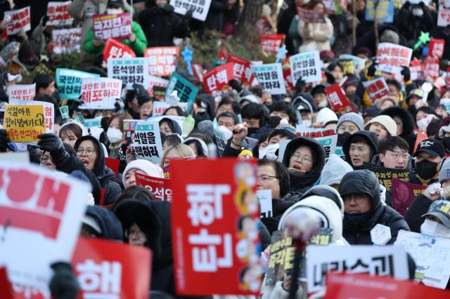 People gather near the National Assembly in Yeouido Seoul calling for President Yoon Suk Yeols impeachment on Dec 14 2024 AJP Han Jun-gu 