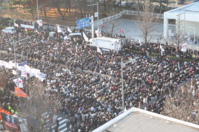 People gather near the National Assembly in Yeouido Seoul calling for President Yoon Suk Yeols impeachment on Dec 14 2024 AJP Han Jun-gu