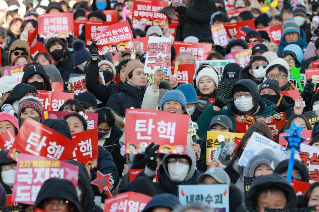 People gather near the National Assembly in Yeouido Seoul calling for President Yoon Suk Yeols impeachment on Dec 14 2024 AJP Yoo Dae-gil