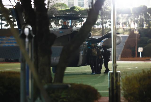 Soldiers descend from a helicopter onto the National Assembly compound in Yeouido Seoul following President Yoon Suk Yeols declaration of martial law on Dec 3 2024