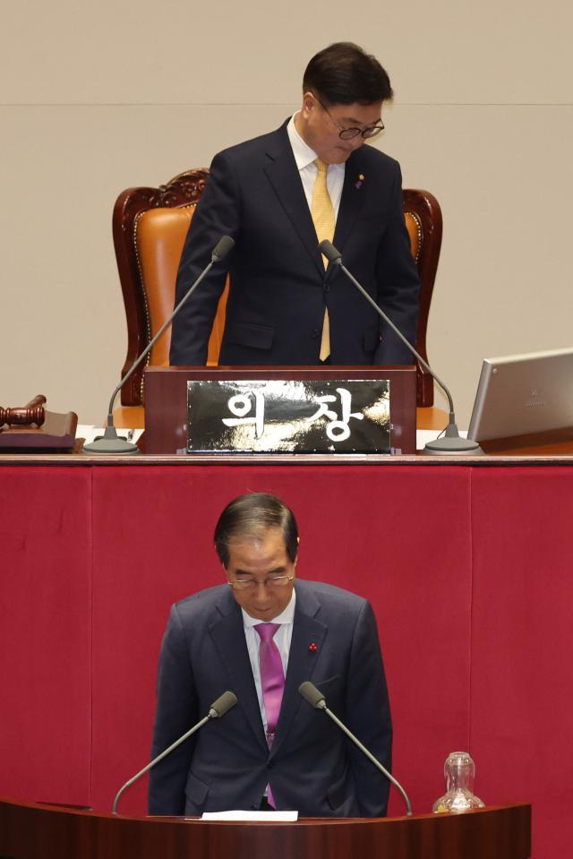 Acting President and Prime Minister Han Duck-soo bows his head for exit after the annual budget plan of 2025 is passed Dec 10 2024 Yonhap