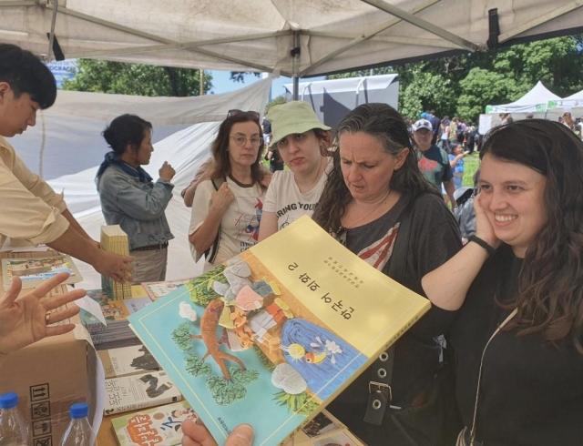 Attendees browse Korean language textbooks at a Korean cultural festival in Buenos Aires on Dec 8 2024 Yonhap