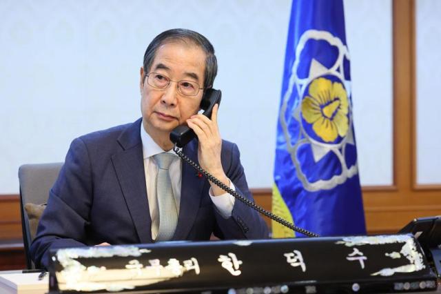 Acting President Han Duck-soo speaks on the phone at the Government Complex in Seoul on Dec 15 2024Yonhap