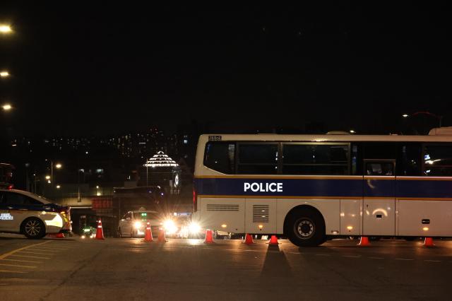 Police trucks and cars block the road near Namtaeryeong Hill in Seoul Dec 22 2024 AJP Han Jun-gu