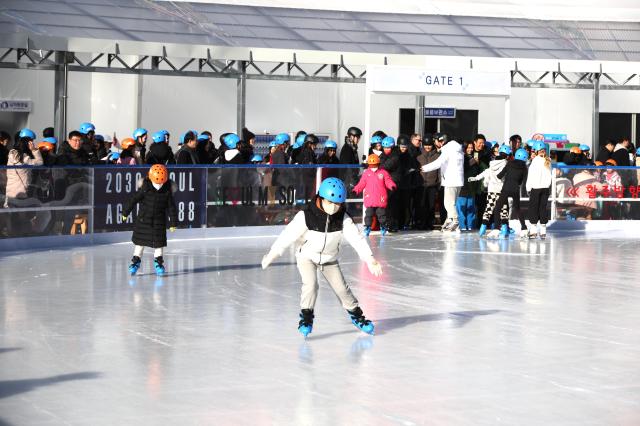 Visitors enjoy ice skating at Seoul Plaza in Seoul Dec 23 2024 AJP Han Jun-gu