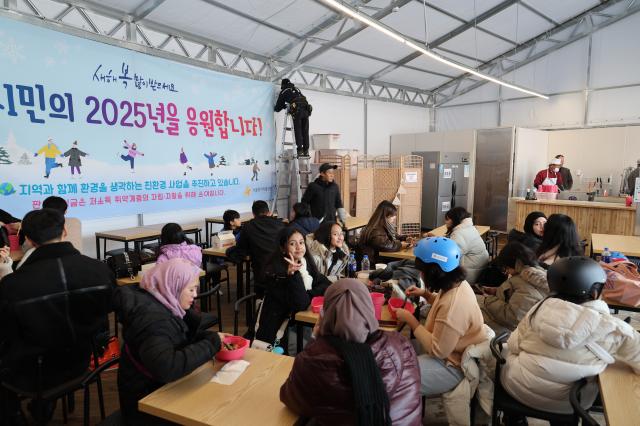 Visitors eat snacks at a concession stand at the ice skating rink at Seoul Plaza in Seoul Dec 23 2024 AJP Han Jun-gu