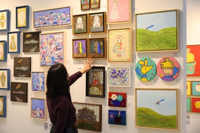 A visitor views artworks at the Art Show at COEX in Seoul Dec 26 2024 AJP Han Jun-gu