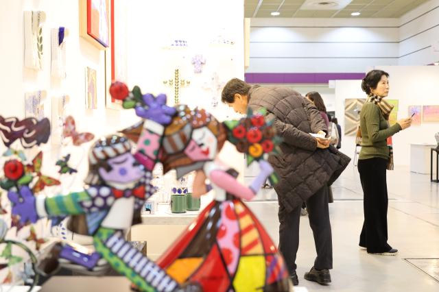 A visitor views artworks at the Art Show at COEX in Seoul Dec 26 2024 AJP Han Jun-gu