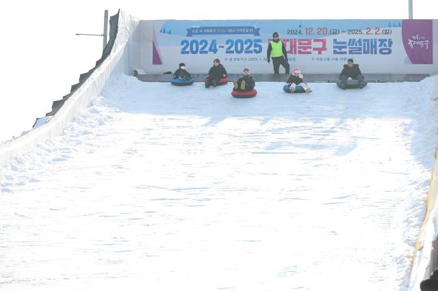 Visitors enjoy sledding at a snow park in Dongdaemun District Seoul Dec 26 2024 AJP Han Jun-gu