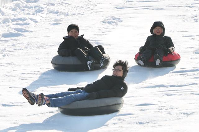 Visitors enjoy sledding at a snow park in Dongdaemun District Seoul Dec 26 2024 AJP Han Jun-gu