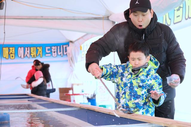 Visitors try hand-net fishing at a snow park in Dongdaemun District Seoul Dec 26 2024 AJP Han Jun-gu