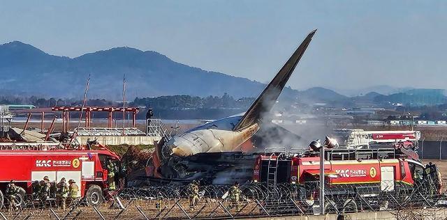 Firefighters conduct rescue operations from a passenger aircraft that crashed at Muan International Airport on Dec 29 2024 Yonhap