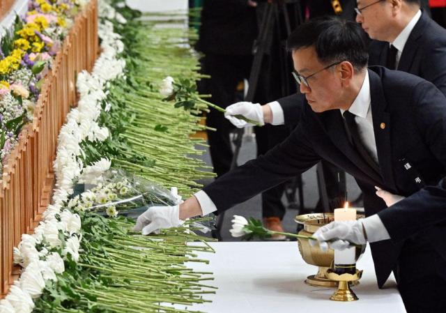 Acting President Choi Sang-mok lays a flower at a memorial altar for the victims of a deadly plane crash in Muan South Jeolla Province on Dec 30 2024 Yonhap