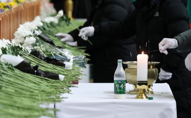 Mourners pay their respects at the joint memorial altar for the victims of a deadly plane crash in Muan South Jeolla Province on Dec 30 2024 Yonhap