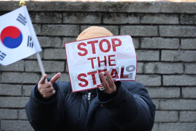 A protester holds a sign at a rally near the Presidential residence in Hannam-dong Seoul on Jan 2 2025 AJP Han Jun-gu